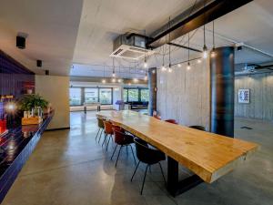 a large wooden table in a room with chairs at Ibis Styles Roma Aurelia in Rome +106 photos