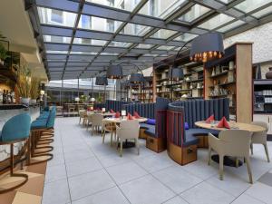 a restaurant with tables and chairs in a building at ibis Styles Zurich City Center in Zurich