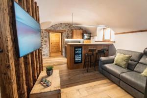 a living room with a couch and a kitchen at Giuly's Home Luxury in Bormio
