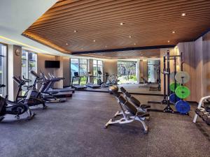 a gym with a bunch of exercise bikes and treadmills at Grand Mercure Malang Mirama in Malang
