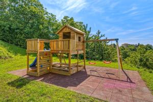 a wooden play house with a slide at Luxury Villa with Indoor Pool and Sauna in Zagreb