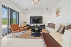 a living room with a couch and a table at Luxury Villa with Indoor Pool and Sauna in Zagreb