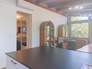 a kitchen with a black counter top in a room at Holiday Home Posidonie by Interhome in LʼÎle-Rousse