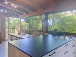 a kitchen with a counter and a clock on the window at Holiday Home Posidonie by Interhome in LʼÎle-Rousse