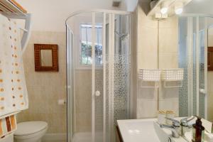 a bathroom with a shower and a toilet and a sink at Le Pape - Chambre in Porticcio +14 photos