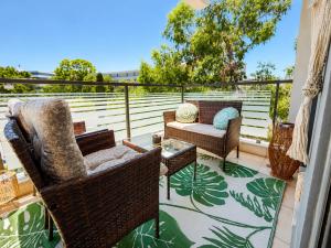 a balcony with chairs and a table and a couch at Fos Opus - Seaside Residence Rhodes in Ixia