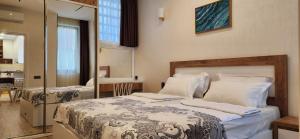 a bedroom with two beds and a mirror at Archie's Apartment in Old Town in Batumi +149 photos