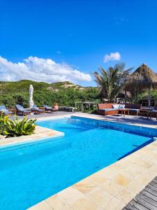 a swimming pool with blue water in a resort at Sava Dunes in Miramar