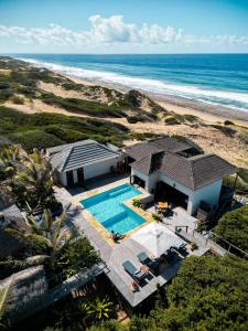 an aerial view of a house and the beach at Sava Dunes in Miramar
