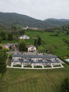 an aerial view of a large house in a field at BedE-Bike Apartments in Casazza