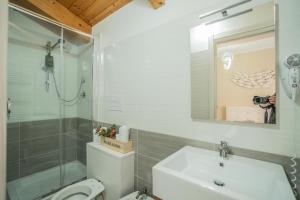 a bathroom with a sink and a shower and a toilet at Oltremura Rooms Agropoli in Agropoli +16 photos