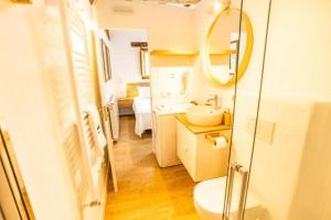 a bathroom with a sink and a mirror at La Cueva Rural Boutique Villa in La Focella +7 photos