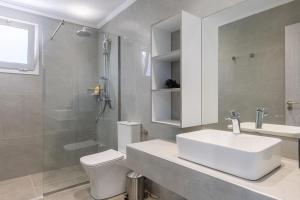a bathroom with a sink and a toilet and a shower at Villa Vibella in Laganas +10 photos