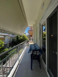 a balcony with a table and a chair on it at Armonia Studio in Paralia Katerinis +5 photos