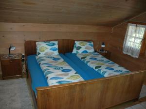 ein Bett in einer Hütte mit zwei Kissen darauf in der Unterkunft Apartment in Frutigen with Garden Terrace in Frutigen