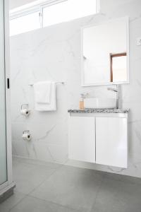 a white bathroom with a sink and a shower at Hotel Rocha in Ribeira Grande +81 photos
