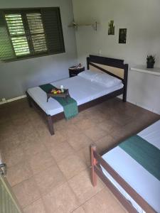 a bedroom with two beds and a table in it at Rancho Dias Mágicos in Uberlândia +36 photos