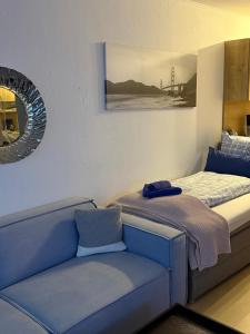 a bed and a couch in a room at BeachPark Sierksdorf in Scharbeutz +22 photos