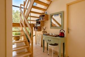 a room with a desk and a staircase with a mirror at Villa Tromelin in Bouc-Bel-Air +15 photos