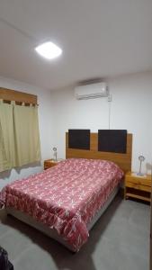 a bedroom with a large bed with a red bedspread at La Niña in Belén