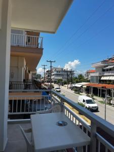 a balcony with a table and a view of a street at Hermes Studio in Paralia Katerinis +5 photos