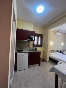 a small kitchen with a bed in a room at Hermes Studio in Paralia Katerinis