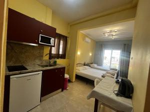 a small kitchen with a bed in a room at Hermes Studio in Paralia Katerinis