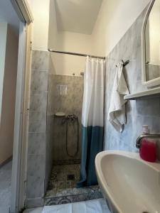 a bathroom with a shower and a sink at Hermes Studio in Paralia Katerinis