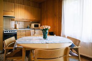 a kitchen with a table with a vase of flowers on it at Näsby apartment with sauna in Houtskari