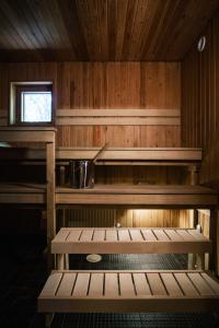 a kitchen with wooden walls and a sink and benches at Näsby apartment with sauna in Houtskari