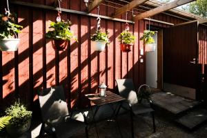 a patio with potted plants on a red wall at Näsby apartment with sauna in Houtskari