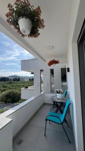 a balcony with a table and chairs and a view at Apartments Bojku in Ulcinj