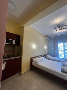 a bedroom with a bed and a sink in it at Eleni Studio in Paralia Katerinis +4 photos