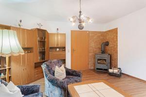 a living room with two chairs and a fireplace at Ferienwohnung sehr ruhig in Pößneck