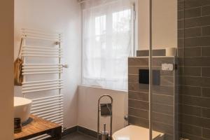 a bathroom with a toilet and a glass shower at Amanthos Living Nyon in Duillier +37 photos