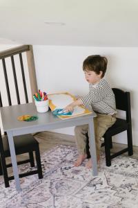a young boy is sitting at a table at Java with Private Spa & Games, Lake & Golf in Saint-Raymond +40 photos
