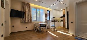 a kitchen and dining room with a table and chairs at Archie's Apartment in Old Town in Batumi