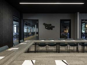 a long table and chairs in a dining room at ibis Styles Friedrichshafen in Friedrichshafen