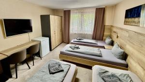 Кровать или кровати в номере Hotel Pension Pamina