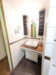 a bathroom with a sink and a mirror at Gite Les Sources in Champagney +23 photos
