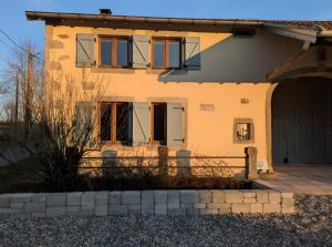 a house with a fence in front of it at Gite Les Sources in Champagney