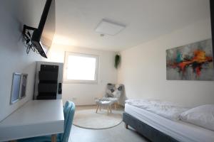 a bedroom with a bed and a tv in it at Walters Weidelbach in Haiger