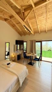 a bedroom with a bed and a table and chairs at Aurea in Dhërmi