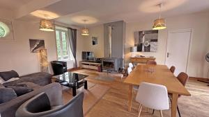 a living room with a couch and a table at Le moulin in Saint-Yrieix-la-Perche