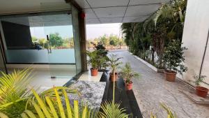 a courtyard with potted plants in front of a building at Hotel Shri Govind in Shirdi