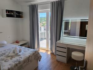 a bedroom with a bed and a desk and a window at Green Lagoon, Hvar island in Vrboska +65 photos