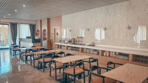 a restaurant with tables and chairs in a room at Dorana Toro Hotel in Kyrenia