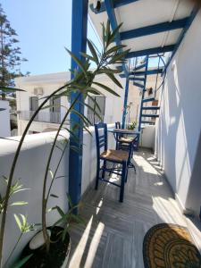 a balcony with two chairs and a table at Manolia Home in Parikia