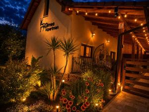 a building with a bunch of plants and lights at Gímes Apartman in Cserszegtomaj