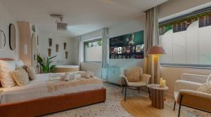 a bedroom with a bed and a couch and a chair at Suite romantique Ibiza, Jacuzzi, Spa in Strasbourg